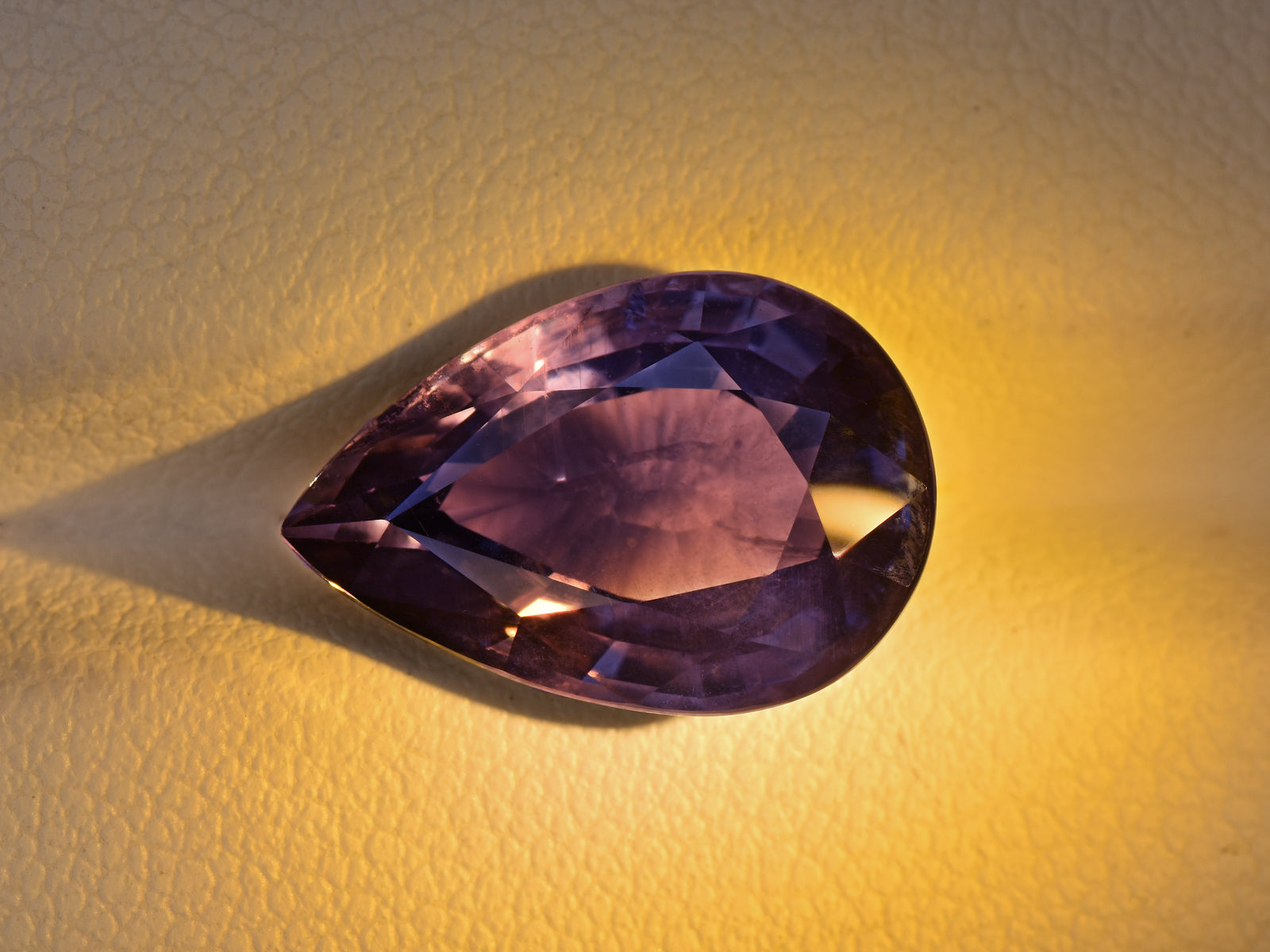 8801741-pear-greyish-violet-changing-to-deep-violet-aigs-tanzania-natural-color-change-sapphire-7.20-ct