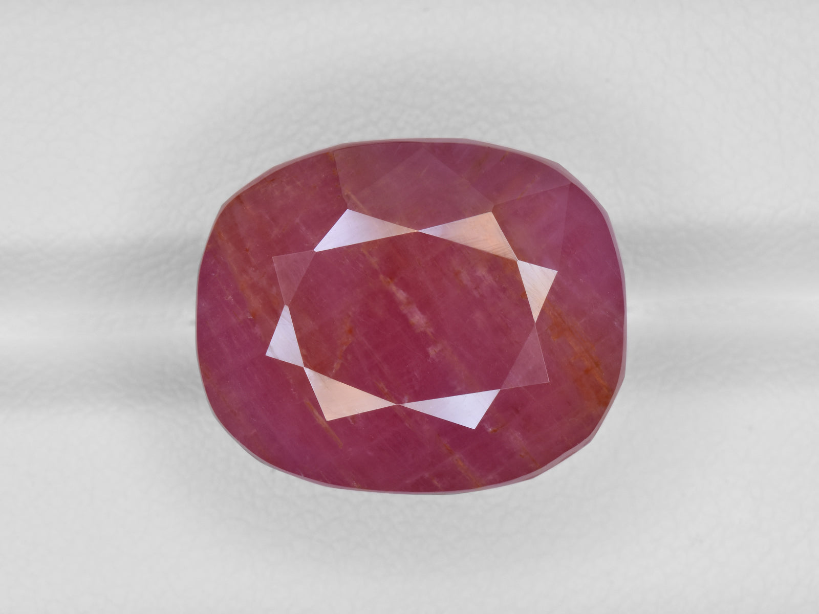 8801239-cushion-pinkish-red-with-orange-staining-gii-guinea-natural-ruby-29.63-ct
