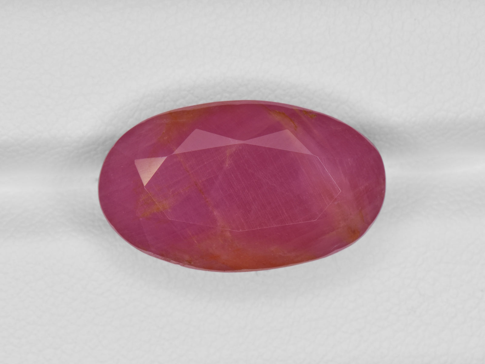 8801246-oval-deep-pinkish-red-with-orange-staining-gii-guinea-natural-ruby-19.62-ct
