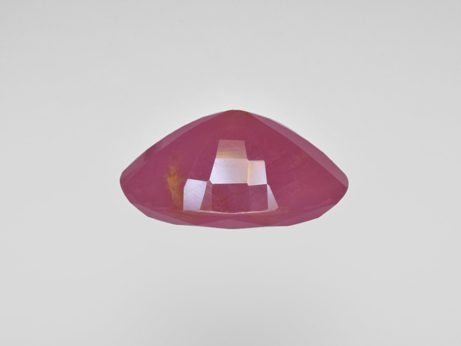 8801246-oval-deep-pinkish-red-with-orange-staining-gii-guinea-natural-ruby-19.62-ct