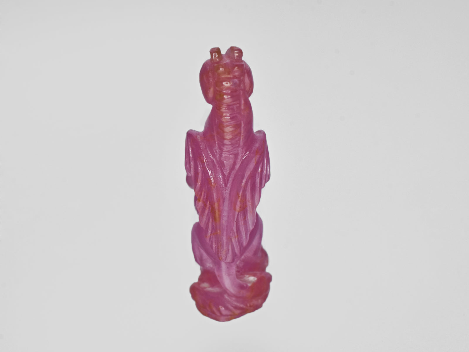 8801537-carved-pinkish-red-gii-guinea-natural-ruby-22.22-ct