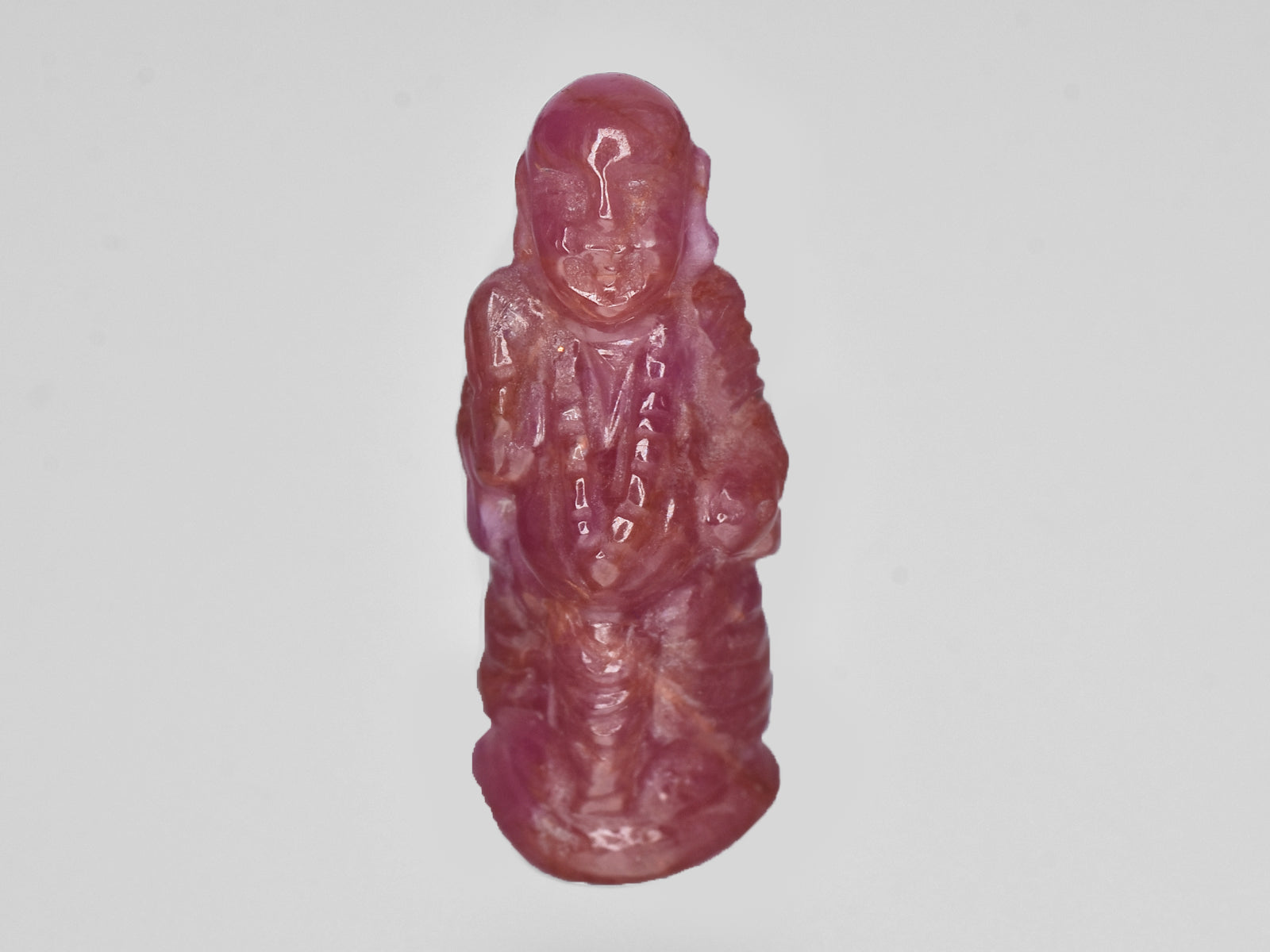 8801538-carved-pinkish-red-with-orange-staining-gii-guinea-natural-ruby-18.61-ct