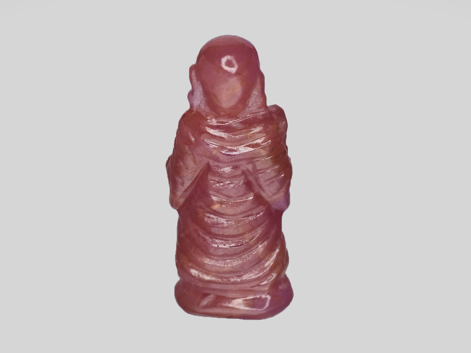 8801538-carved-pinkish-red-with-orange-staining-gii-guinea-natural-ruby-18.61-ct