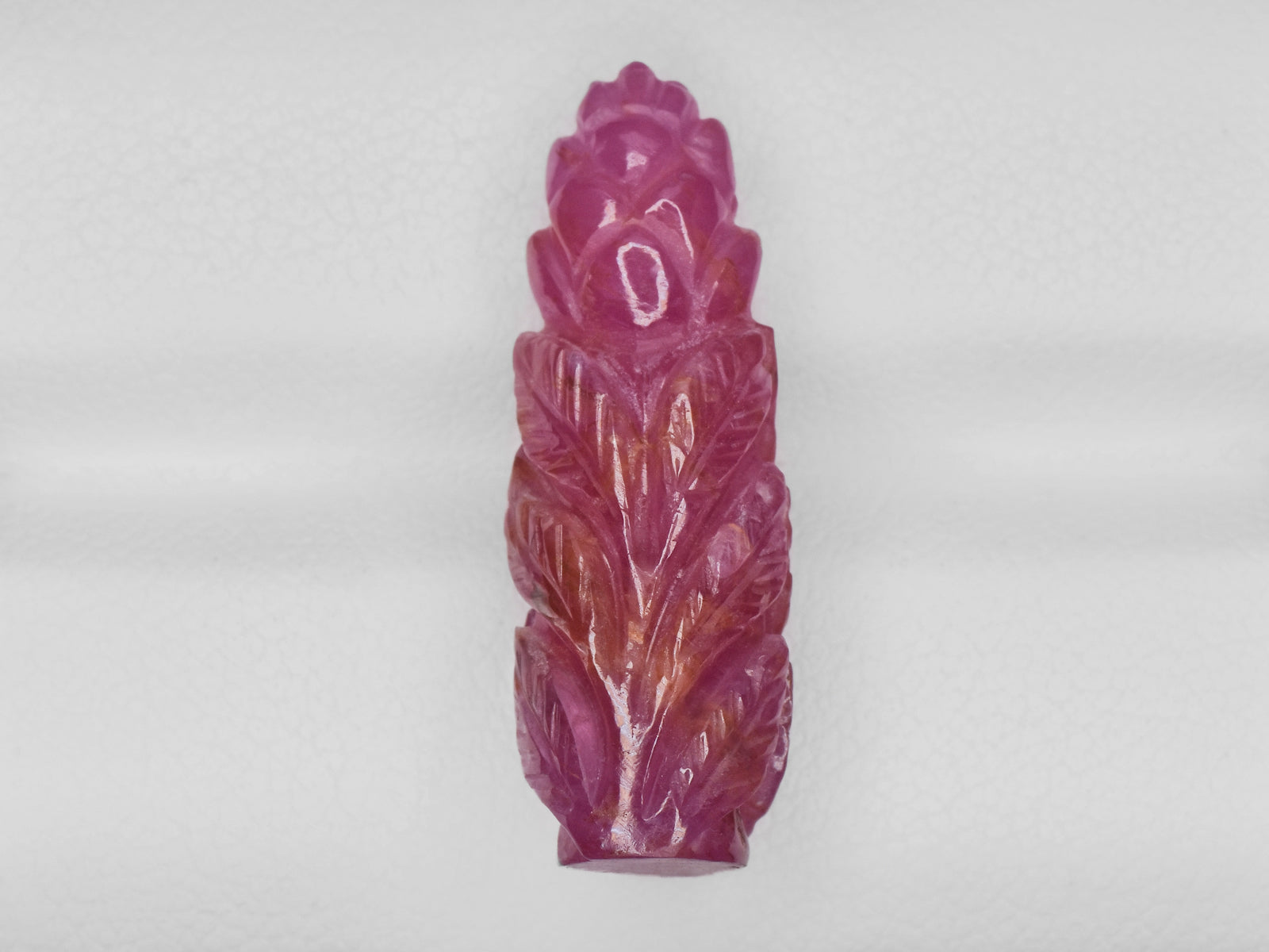 8801542-carved-pinkish-red-gii-guinea-natural-ruby-18.10-ct