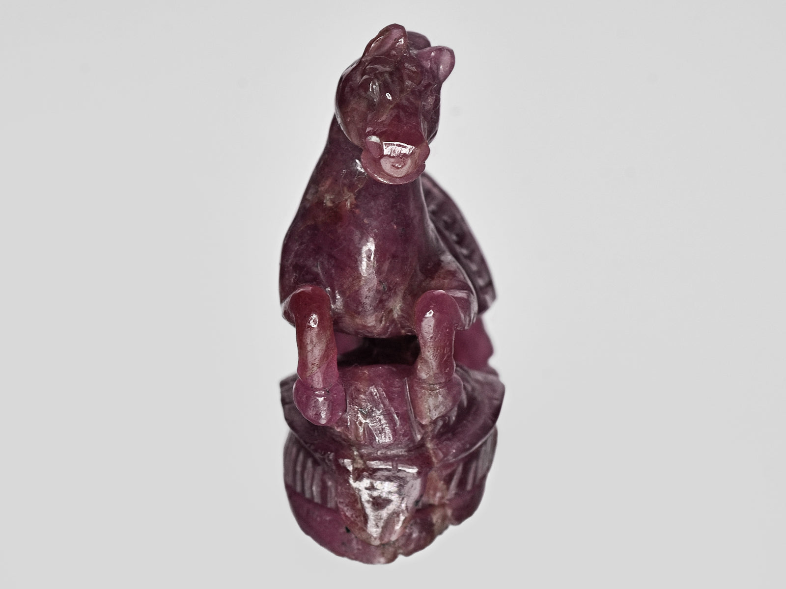 8801462-carved-glossy-purplish-red-gii-guinea-natural-ruby-63.04-ct