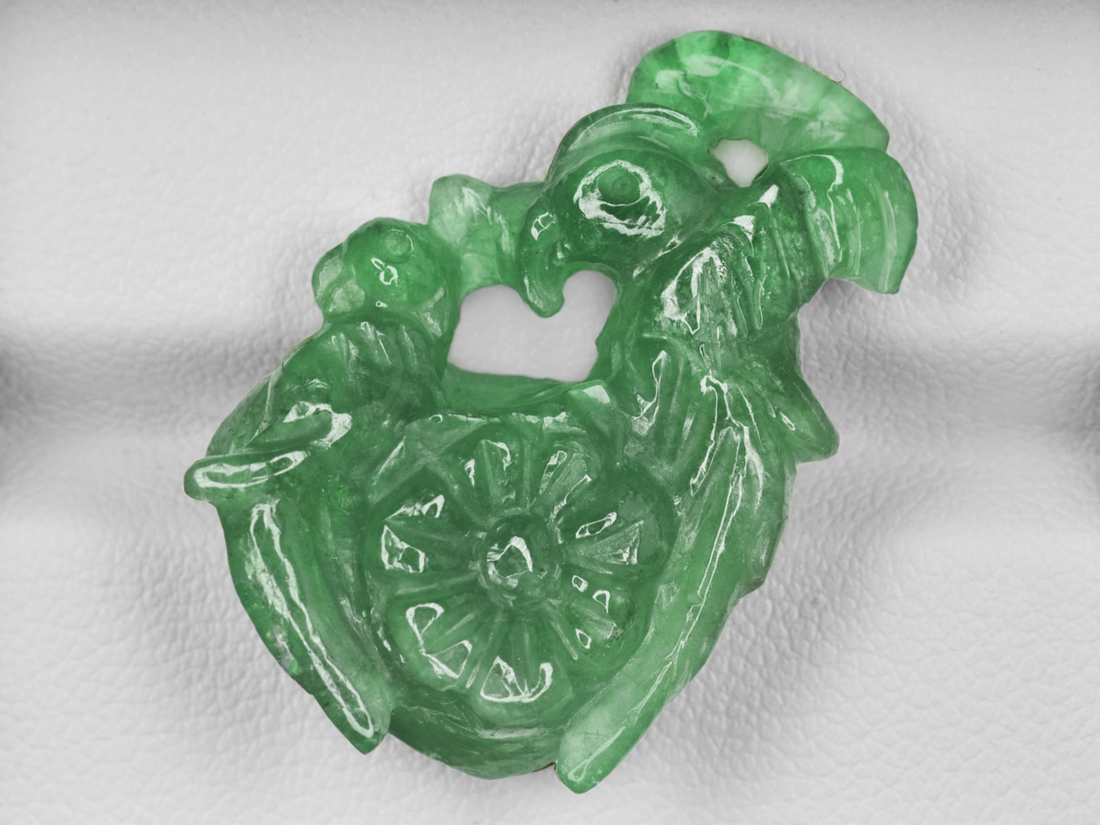 8801470-carved-bright-green-gii-zambia-natural-emerald-21.11-ct