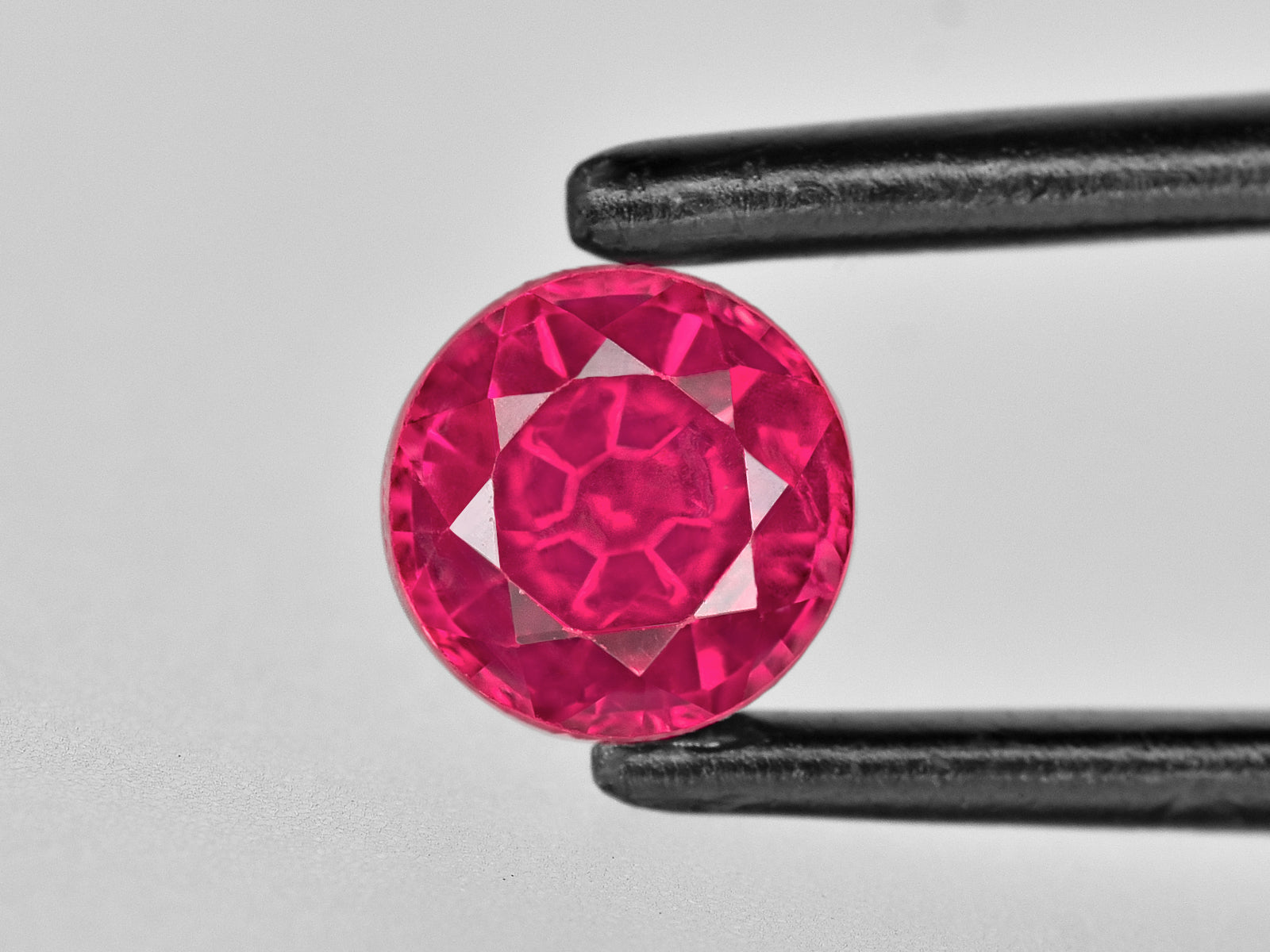 8802739-round-bright-pinkish-red-igi-tanzania-natural-ruby-0.73-ct
