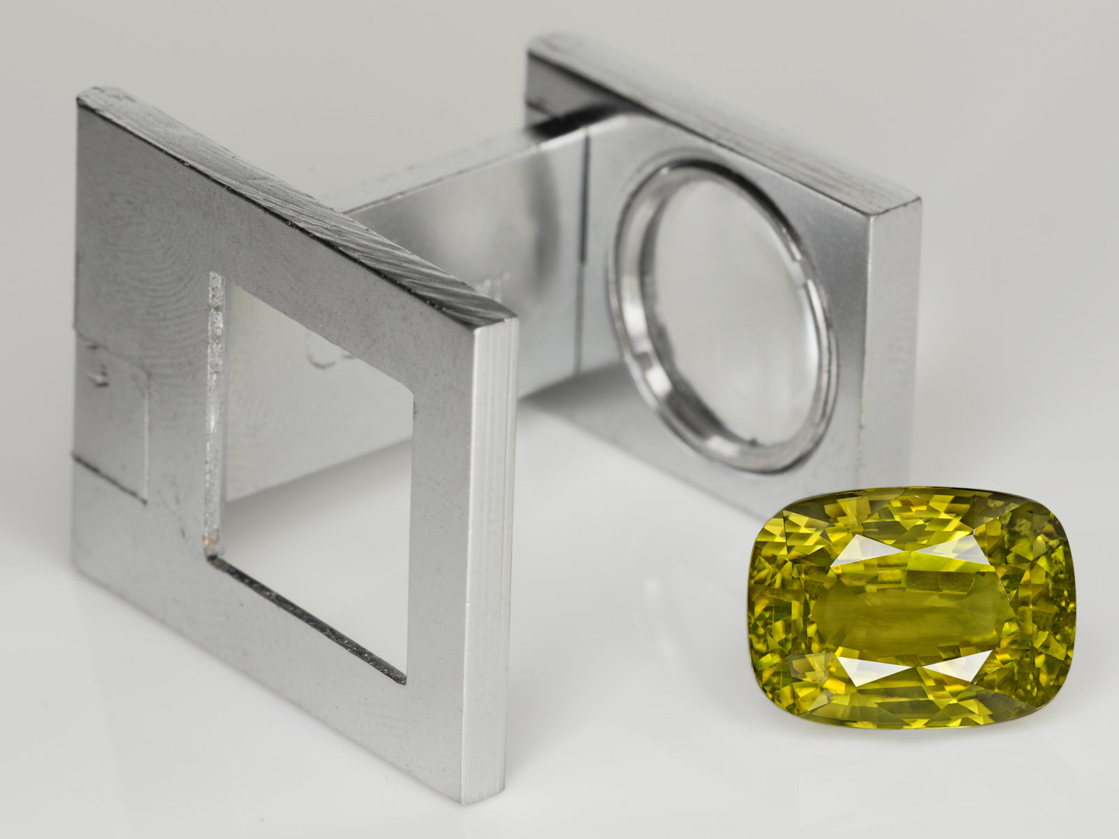 8803078-cushion-intense-yellowish-green-changing-to-brownish-yellow-gia-madagascar-natural-alexandrite-12.28-ct
